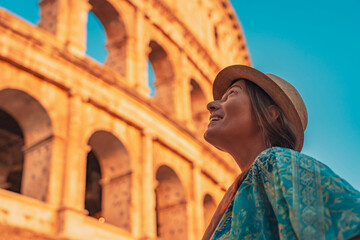 08 08 2025 Rome, Italy - Tourist woman smiling near Colosseum at sunset