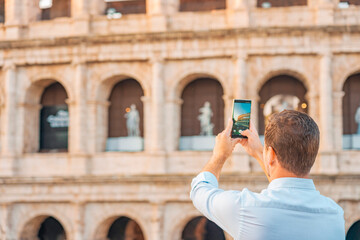08 08 2025 Rome, Italy - Tourist taking photo of Colosseum with smartphone