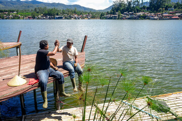 Friends Celebrate Fishing Success With High Five at Scenic Lake