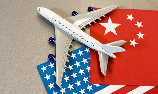 Chinese flag in front of a passenger airplane at the airport, overlaid with financial graphs, symbolizing China global trade, economy, and transportation industry.