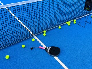 padel racket on a padel blue court 