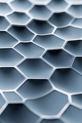 Fototapeta premium Intricate honeycomb structure with smooth grey surfaces and white borders, suggesting advanced material science and microscopic detail