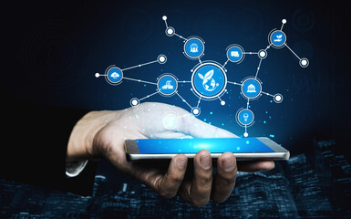 A hand holds a smartphone showcasing various eco-friendly technology icons connected through networking elements, symbolizing innovation and sustainability. Tessel