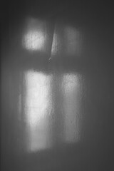 Abstract light reflection and grey shadow from window on white wall background, dark gray shadows and sunshine overlay effect for backdrop and mockup design Black and white Painting wooden door