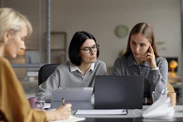Two Young Adult Caucasian Women Collaborating on Project Using Laptop Computer