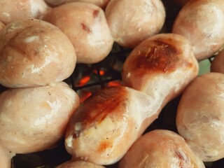 Grilled beef sausages on a charcoal grill