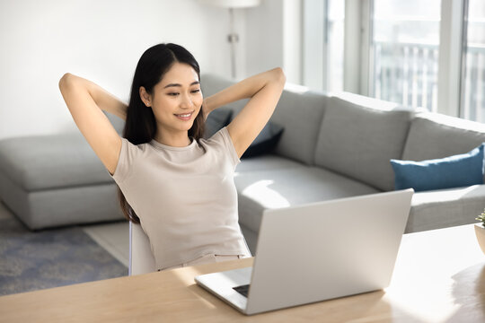 Woman relaxing after work on laptop at homeoffice