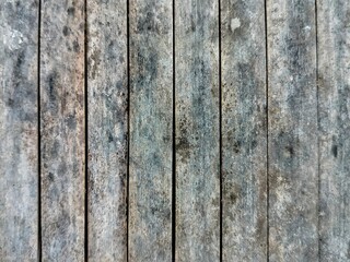 Textural details of several weathered and worn wooden planks arranged vertically.