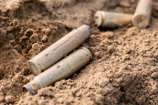 Empty carbine or rifle large-caliber cartridges. A large number of cases. Background of brass ammunition cartridges