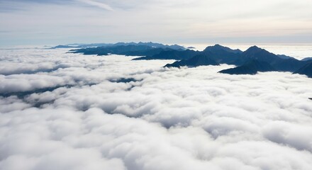 Obraz premium Aerial view of mountain peaks above a sea of clouds. Majestic high altitude landscape scenery. Nature and travel background