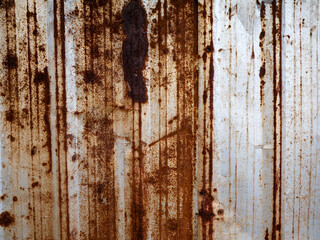 Heavily Rusted Corrugated Metal Sheet with Vertical Rust Streaks and Corrosion Patterns