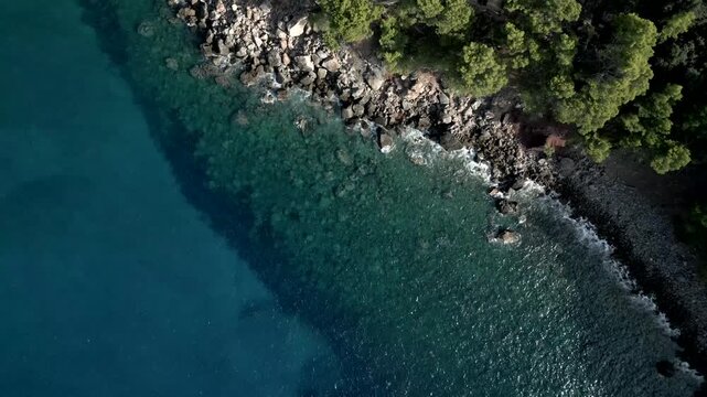 90 degrees view, rocks coast in a sunny day. Transparent water. Spain. Mallorca. Video 4K