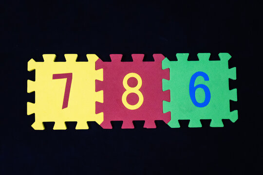 Islamic holy Number 786 on Jigsaw Puzzle on black background