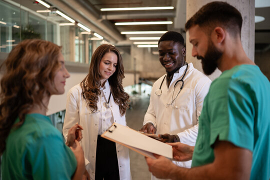 Diverse medical team collaborating on patient charts