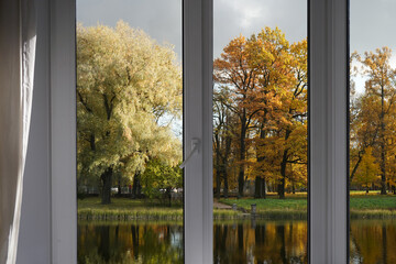 Window frame, view from the window  on yellow trees, landscape with autumn forest.