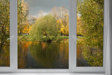 Window frame, view from the window  on yellow trees, landscape with autumn forest.
