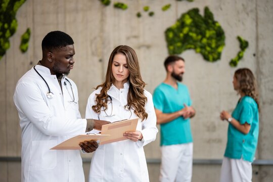 Medical team collaborating, discussing patient records