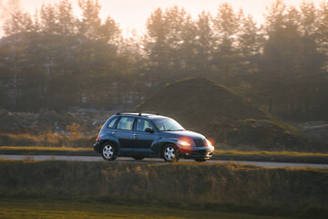 Fototapeta premium Modern car driving through scenic surroundings