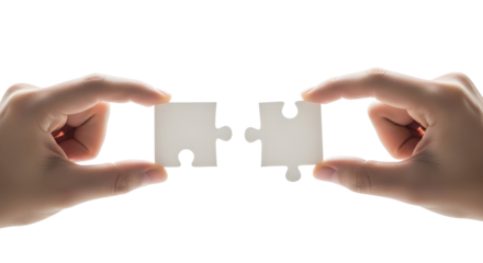 Pair of Human Hands Holding Two White Jigsaw Puzzle Pieces, About to Connect Them, Symbolizing Problem Solving, Teamwork, and Partnership to Achieve a Unified Solution on a Bright White Background