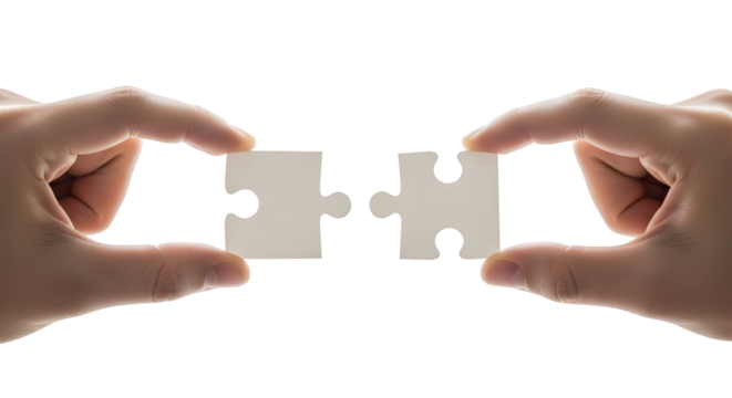 Close-up of human hands about to connect two interlocking jigsaw puzzle pieces, representing synergy, completion, business strategy, and finding the perfect solution for integration