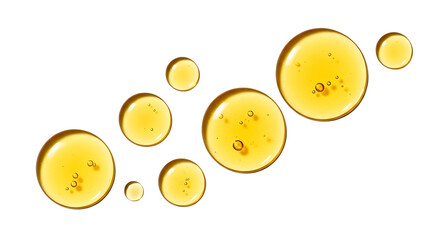 Fototapeta premium Close up macro shot of golden yellow liquid oil droplets with air bubbles suspended on a clean white background