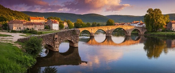 A peaceful village is nestled along a calm river