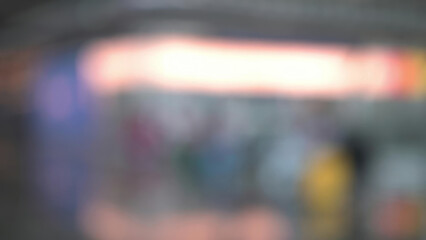 Blurred figures moving in architectural airport space