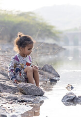 playful moment of kid dipping feet in lake calm water