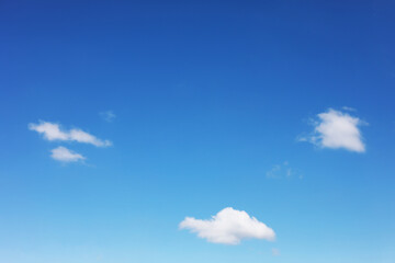 Blue sky background and white clouds soft focus, and copy space horizontal shape.
