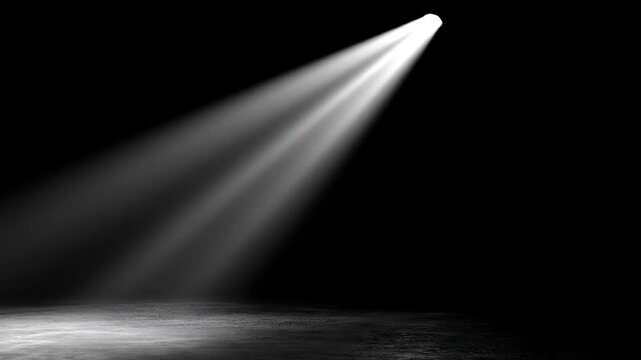 Dramatic spotlight beam illuminating empty stage dark background