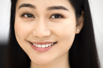 Close up young 25s beautiful Asian woman looks at camera
