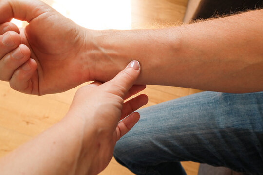 Doctor examining lipoma on patient's forearm