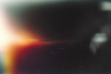Fototapeta premium light leak overlay effect with scratch dust and blur orange light leaks,retro noisy film texture light leak flare on black background,abstract background with ray light,grunge old film burn background