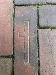 a cross in the stone from a square in front of a church