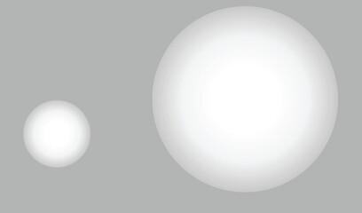 Two white eggs of different sizes on a gray background