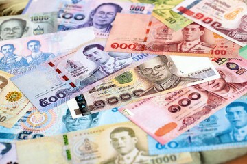 Thai baht currency money. The current banknotes lies on table in big amount close up