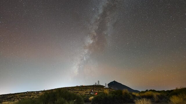 4K time lapse showing the Milky Way setting over Teide Observatory in Tenerife, Canary Islands, with Mount Teide in the background. The galactic core drifts across the sky above the volcanic landscape