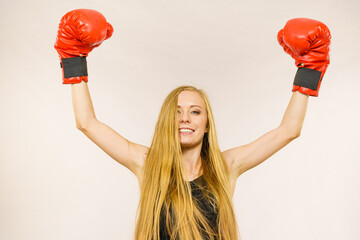 Woman in red gloves with arms up
