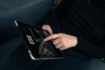 Sustainable Strategy: Professional woman Interacting with ESG Data Dashboard and charts on Tablet