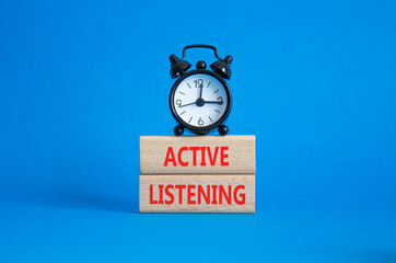 Listen actively symbol. Wooden blocks with words Listen actively. Beautiful blue background with...