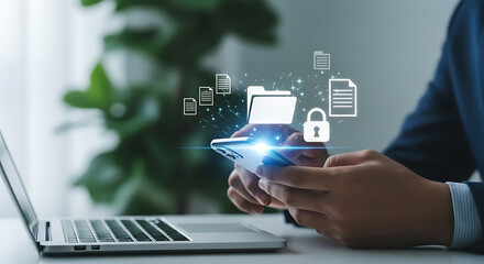 Business person using smartphone for secure file management, data protection, and confidential document access with laptop visible in background.