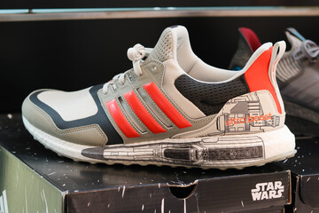 Naklejka premium TOKYO, JAPAN - June 17, 2022: Star Wars adidas sneakers on display in a pop-up Star Wars store, promoting the new TV series, in Tokyu Plaza shopping center.