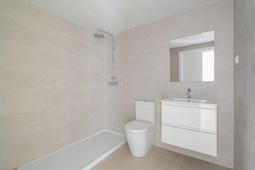 Modern bathroom with a shower, toilet, and sink. Neutral color scheme with light tiles and a large mirror. Clean and minimalist design.