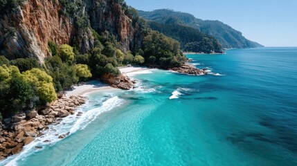 Dramatic Ocean Cliffs with Lush Green Foliage Meet Turquoise Waters and Sandy Beach Under Bright Sunlight