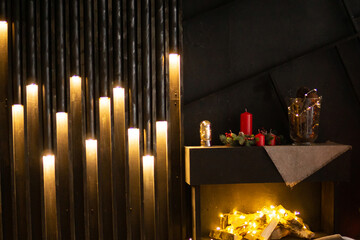 Christmas interior with illuminated wall decor, fireplace with garland, and festive candles on a...