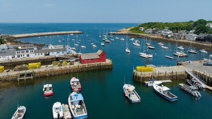 Aerial view of Motif Number 1 overlooking the harbor filled with boats, and the ocean beyond. Rockport, Massachusetts, USA.