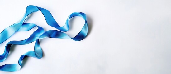 Elegant blue ribbon on white background, creating a sense of luxury