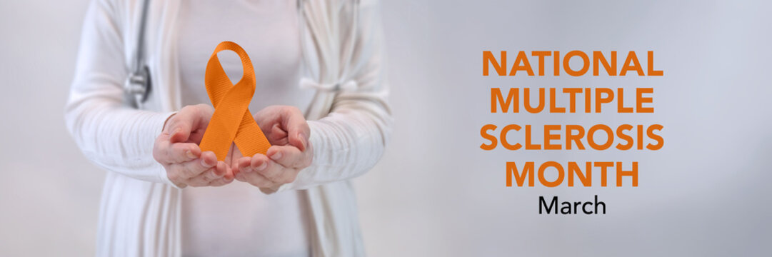 Doctors Hands Presenting Orange Awareness Ribbon - Multiple Sclerosis Awareness Concept