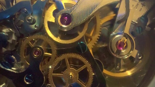 Macro video on a manual winding watch Swiss watch movement with the spring drive beating and the gears turning