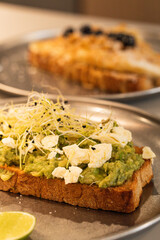 Avocado toast with cheese and sprouts for breakfast